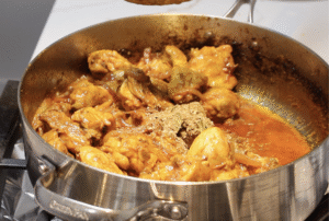 Grounded spices added in into the chicken curry.