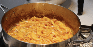 Frying onion in the cooking pot.