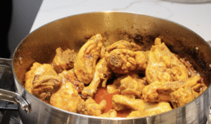 Chicken pieces cooking in the pot.