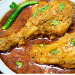 Cooked chicken pieces with green chilli and coriander leaves.