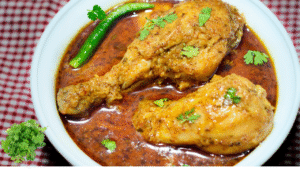 Cooked chicken pieces with green chilli and coriander leaves.