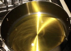 Mustard oil heating in a cooking pot.