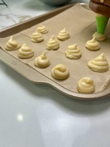Lining up the Choux Pastry in baking tray.